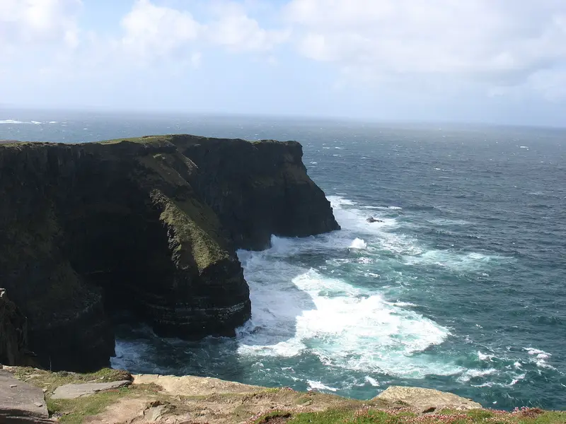 Waves crashing at the base of the cliffs near Hag's Head