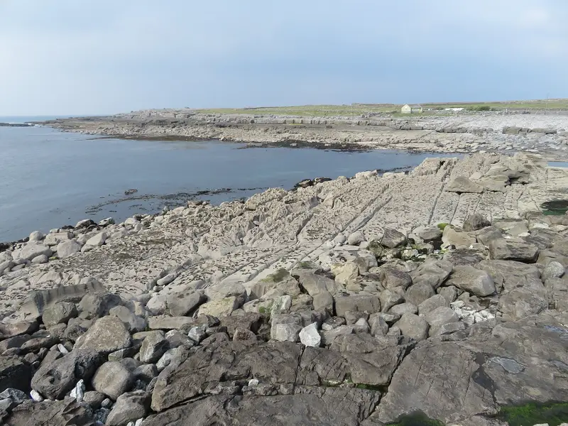 Flat limestone shore and boulders beside the sea near Doolin Pier